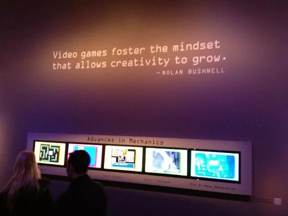 A gallery wall quote from Nolan Bushnell above a row of five game screens